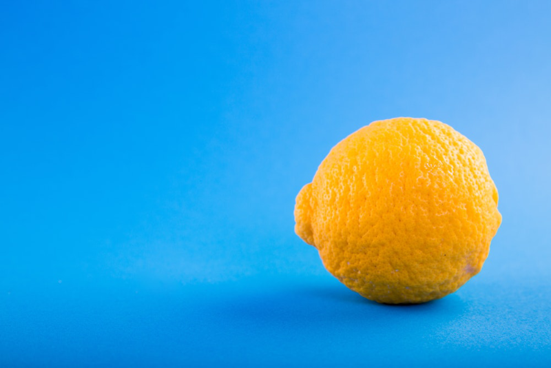 Yellow lemon on blue background