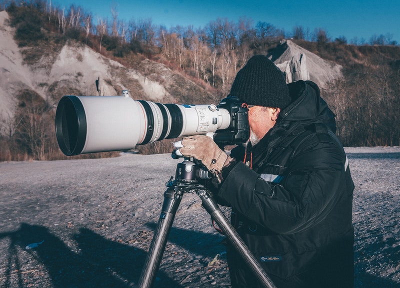 Photographer using a telephoto lens