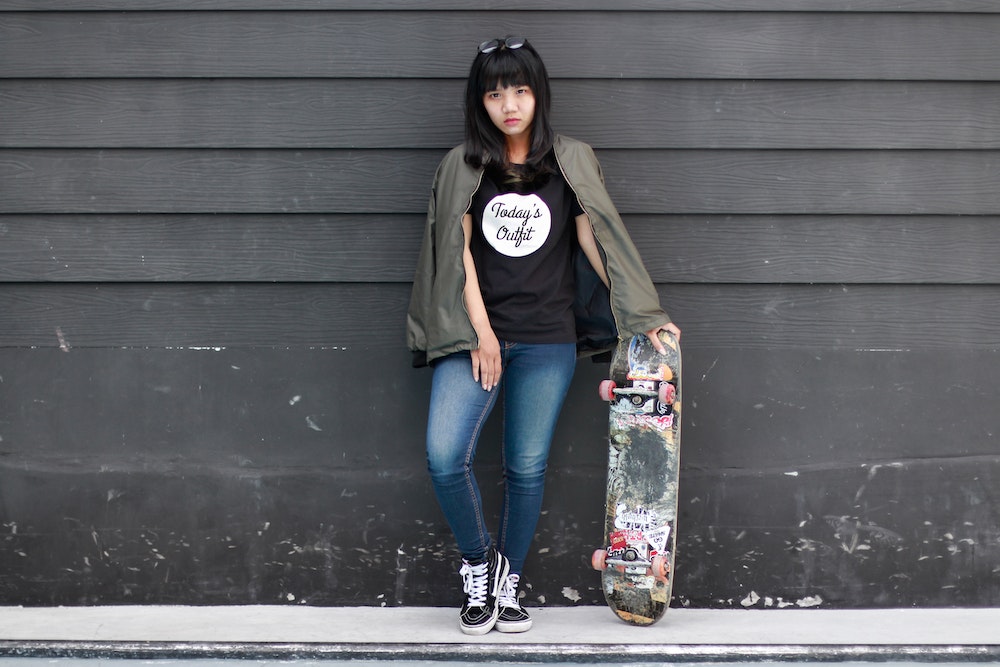 Closed composition of woman with skateboard